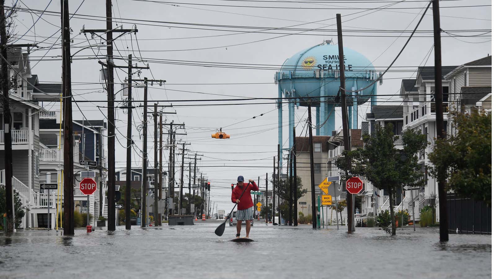 A man paddleboards along a flooded street following heavy rainfall in Sea Isle City, New Jersey, U.S., on Sept. 27, 2026. New York, Boston and Philadelphia were all in the firing line of the nor'easter which brought flooding, downed trees and damaged power lines.