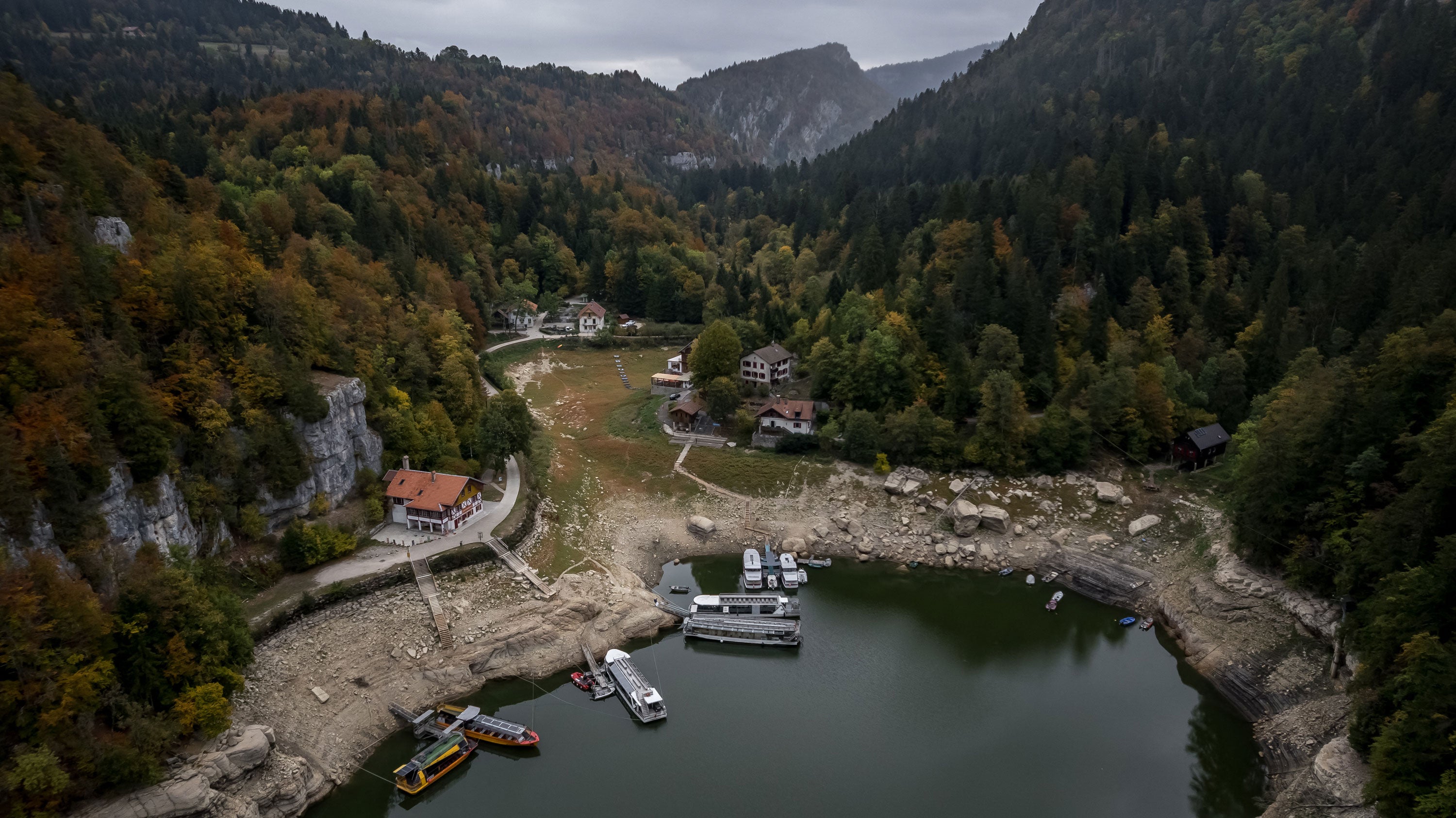 This aerial photograph shows the remaining basin in the northern part of Lake Brenets, part of the Doubs River forming a natural border between eastern France and western Switzerland, which dried up in July 2026, in Les Brenets, Switzerland, on Oct. 1, 2026. 