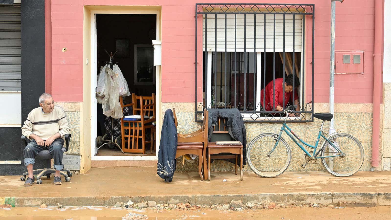 Residents clean their house after floods in Madrigueras, near Albacete, southeastern Spain, on Oct. 3, 2026. A 102-year-old woman died in her home following floods in Madrigueras, where heavy rains fell for several hours on Oct. 2.