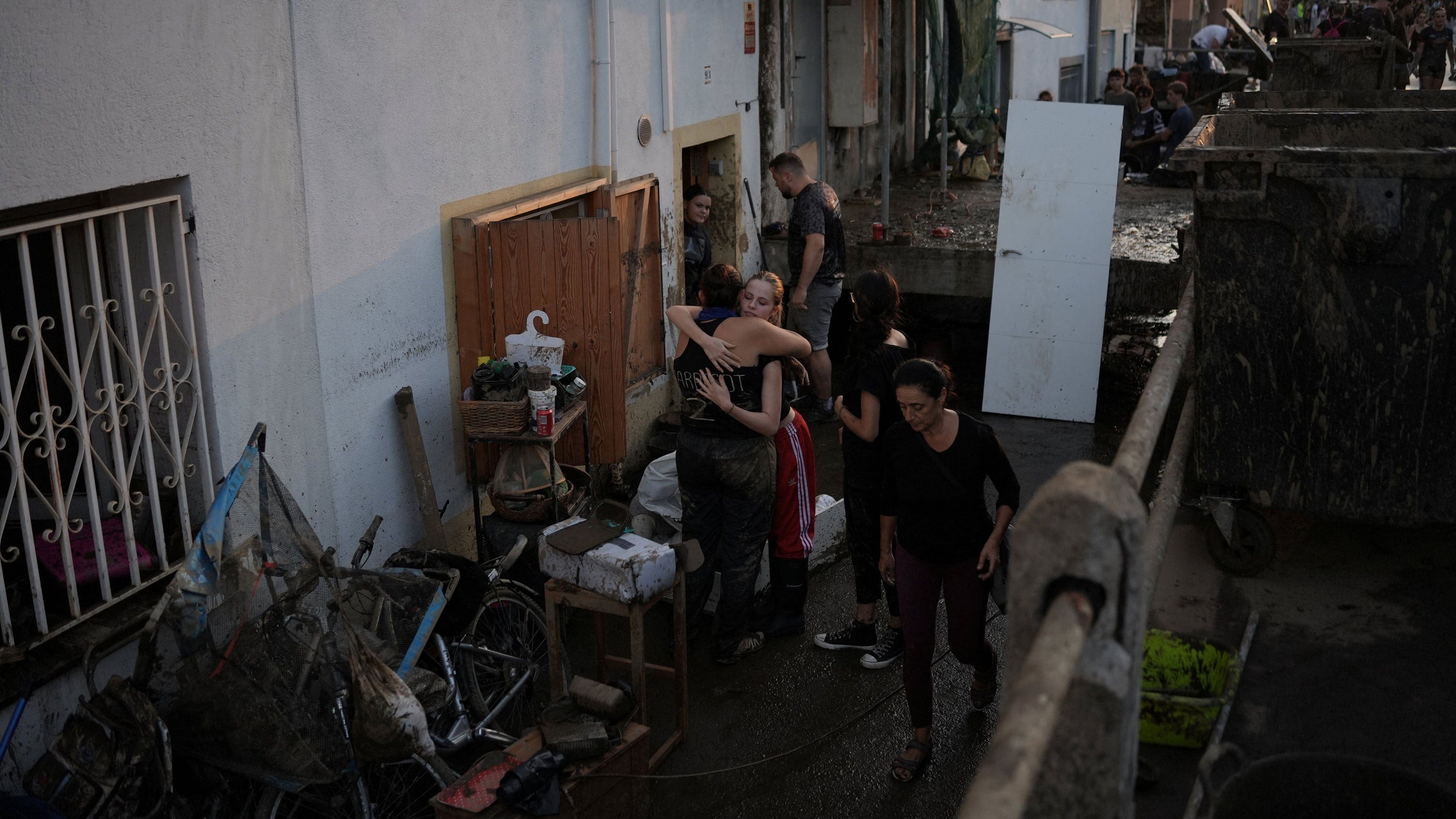 Residents hug as they clean their flooded house after torrential rains in Pineda de Mar, north of Barcelona, on Oct. 4, 2026. Torrential rains battering eastern Spain have left two dead and kept the city of Barcelona and its surrounding areas on high alert, authorities said today, warning of the risk of flooding and overflowing rivers.