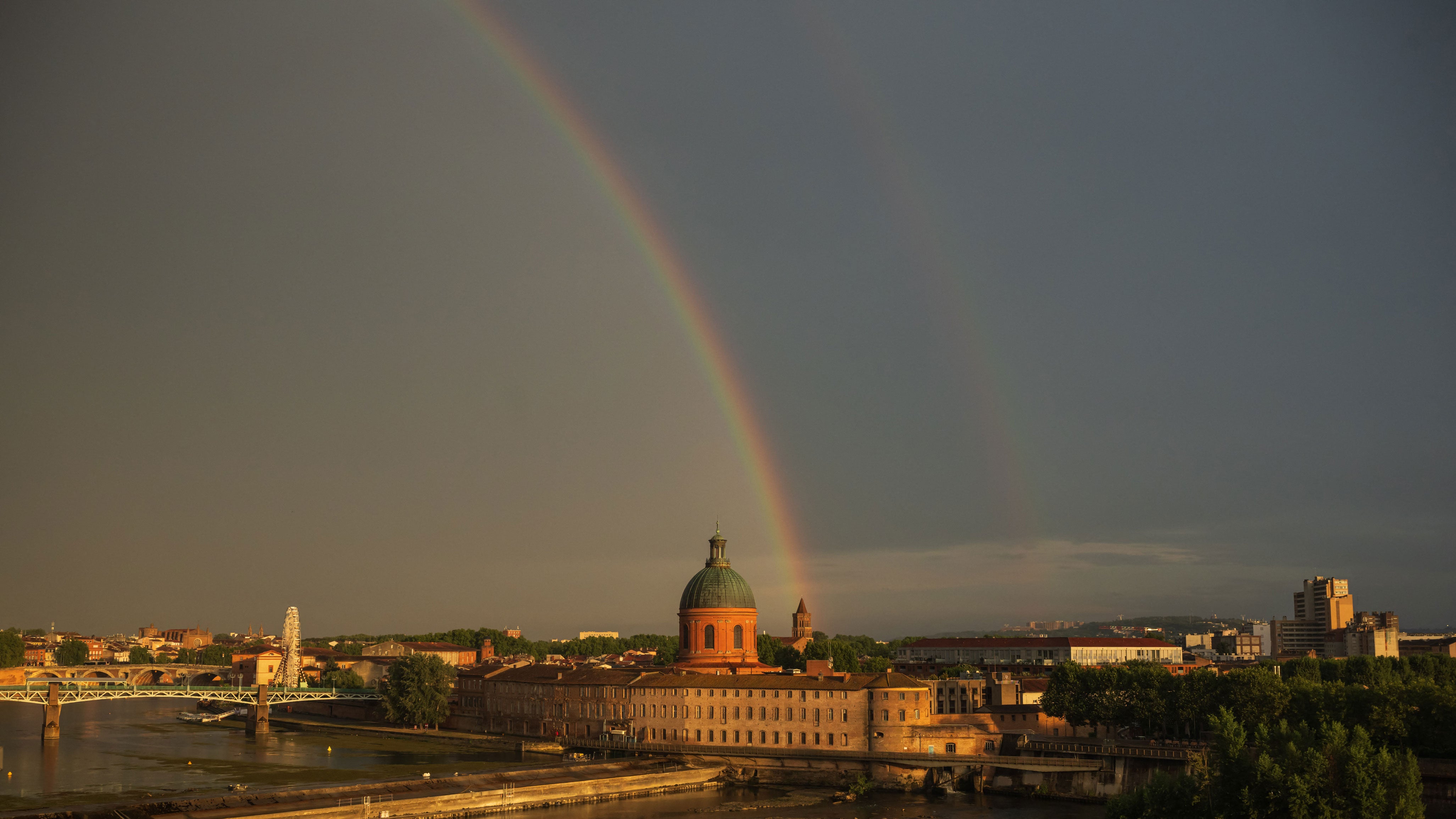 A rainbow over the Garonne River and landmark Dome de la Grave following a thunderstorm in central Toulouse, southern France, on Aug. 3, 2026.