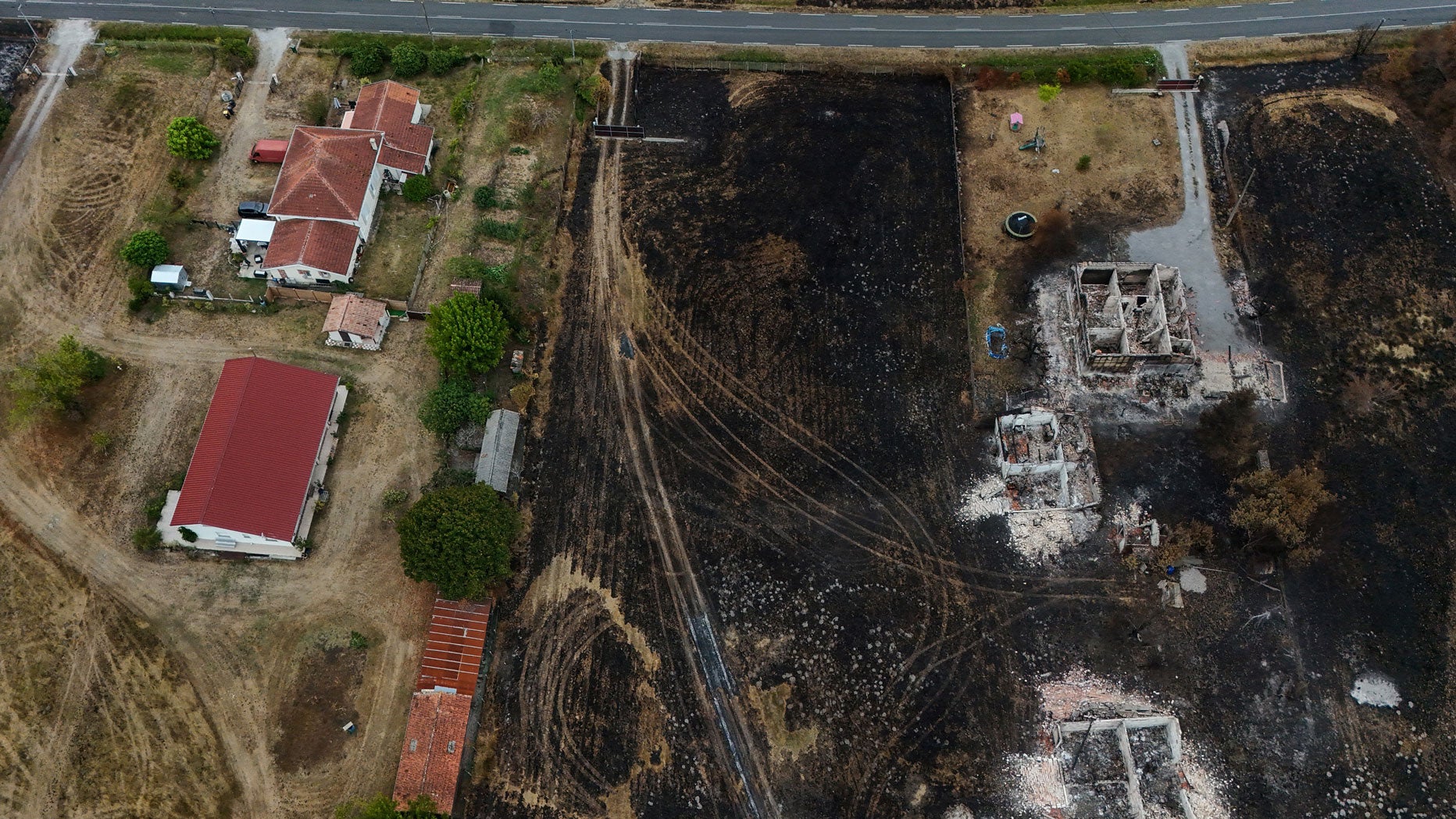Burnt and intact properties in an area hit by the wildfire that swept through the Gironde region in Le Porge, south-western France, on Aug. 6, 2026. Around 240 homes were destroyed by the flames, according to a provisional assessment at the time. 