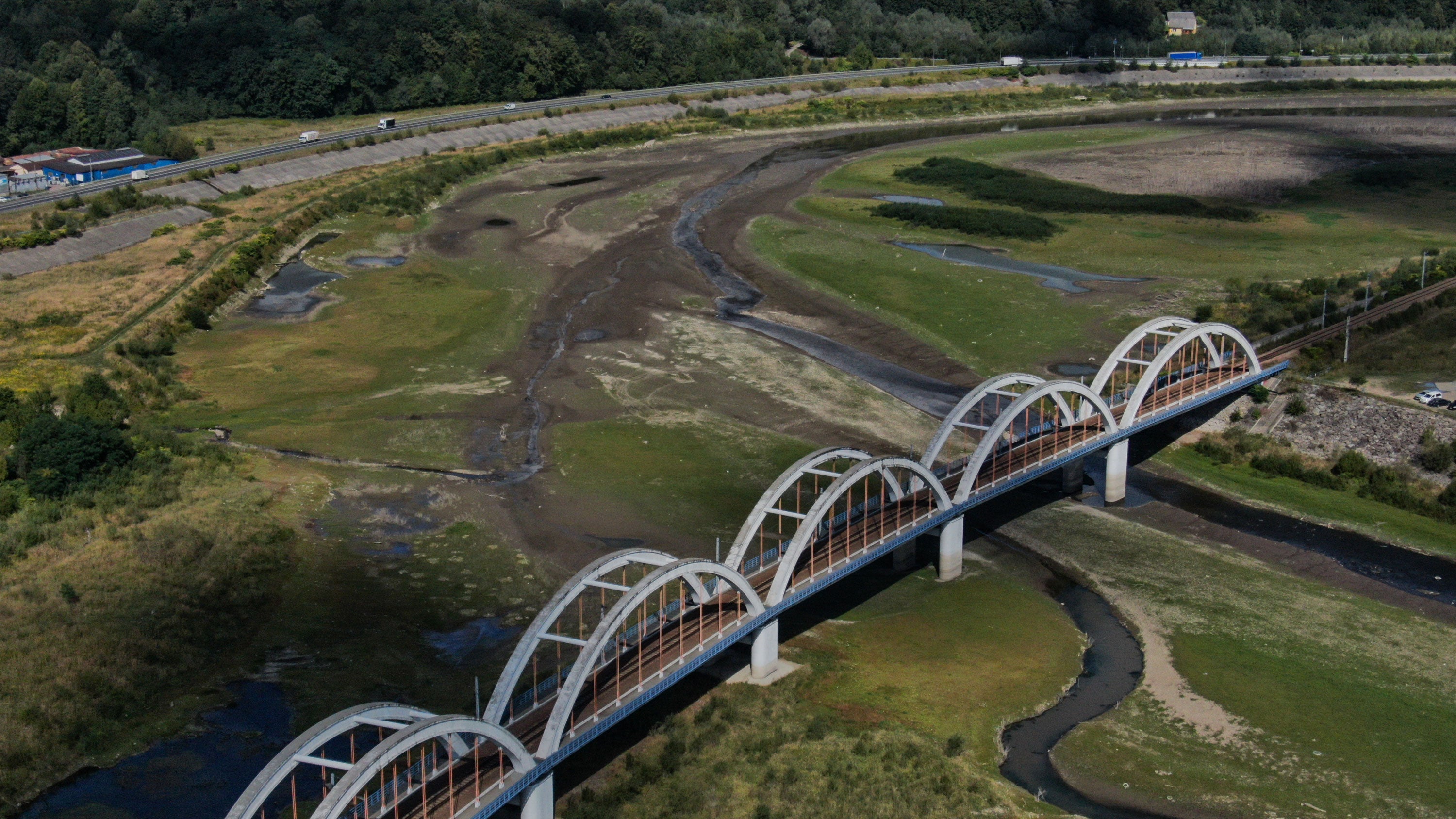 A railway bridge above the almost dried Skawa river amid drought conditions on Tuesday, September 1, 2026, in Zembrzyce, Poland. The river is among many in Europe experiencing severely low water levels, posing challenges to trade and tourism.