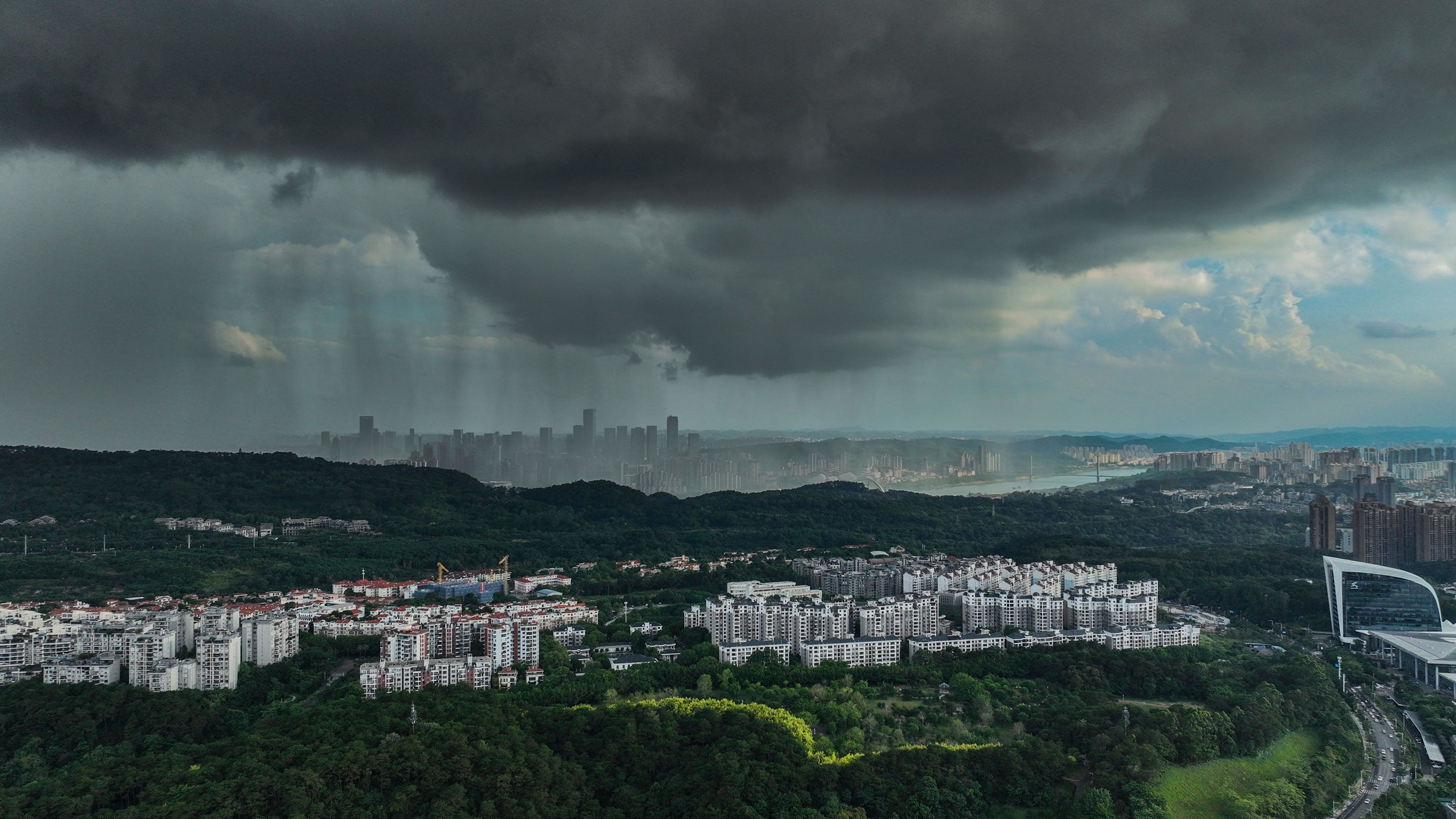 Dark clouds gathered and heavy rain poured down in the southeastern part of Nanning City, Guangxi Province, China on June 13, 2026. 