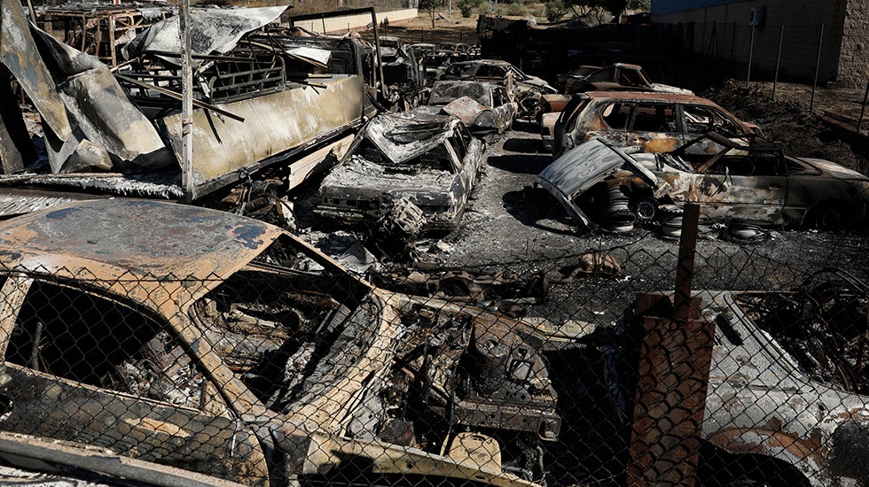 A wildfire in Chapineria, about 30 miles west of Madrid, left burned out hulks of vehicles on Monday, July 27, 2026. 